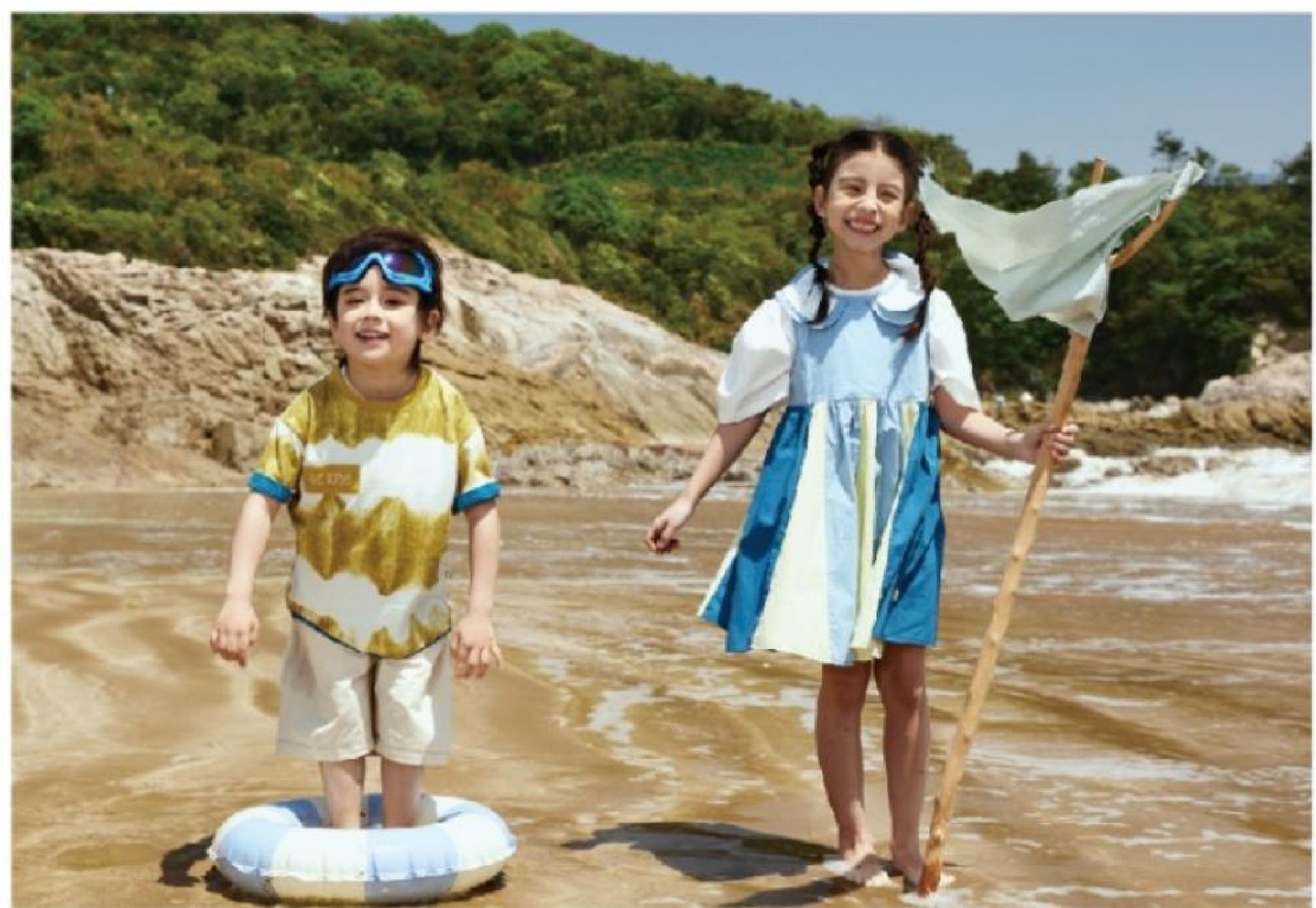 Two children in fully styled DC Kids beach outfits