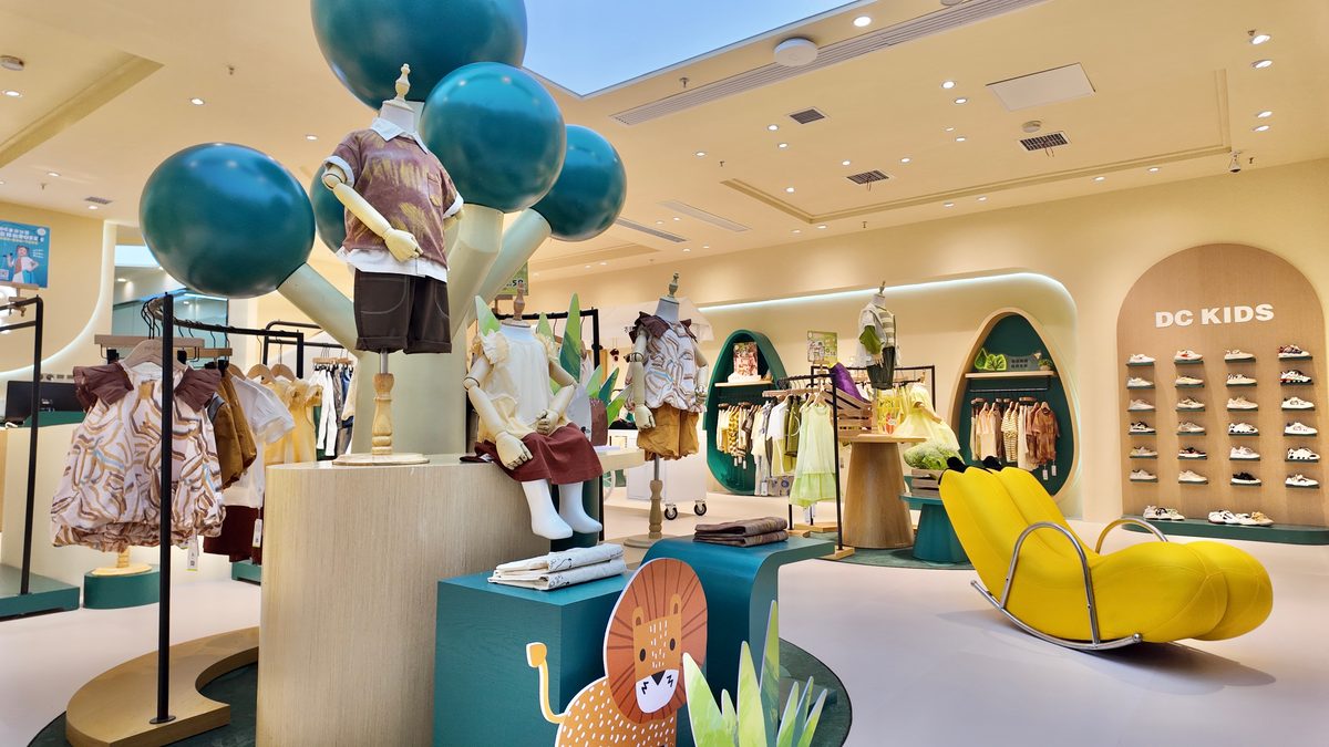 DC Kids store interior — tree display with styled mannequins and shoe wall