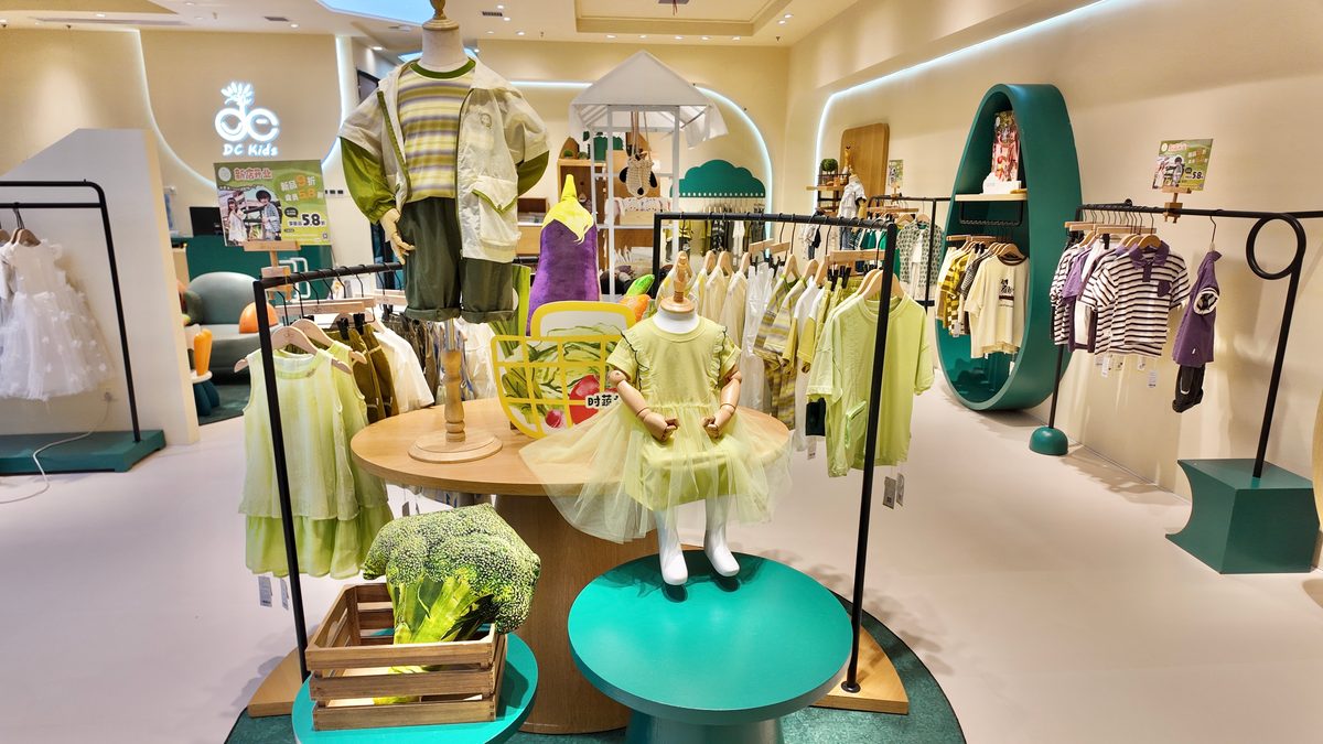 DC Kids store interior — central styling table with complete looks